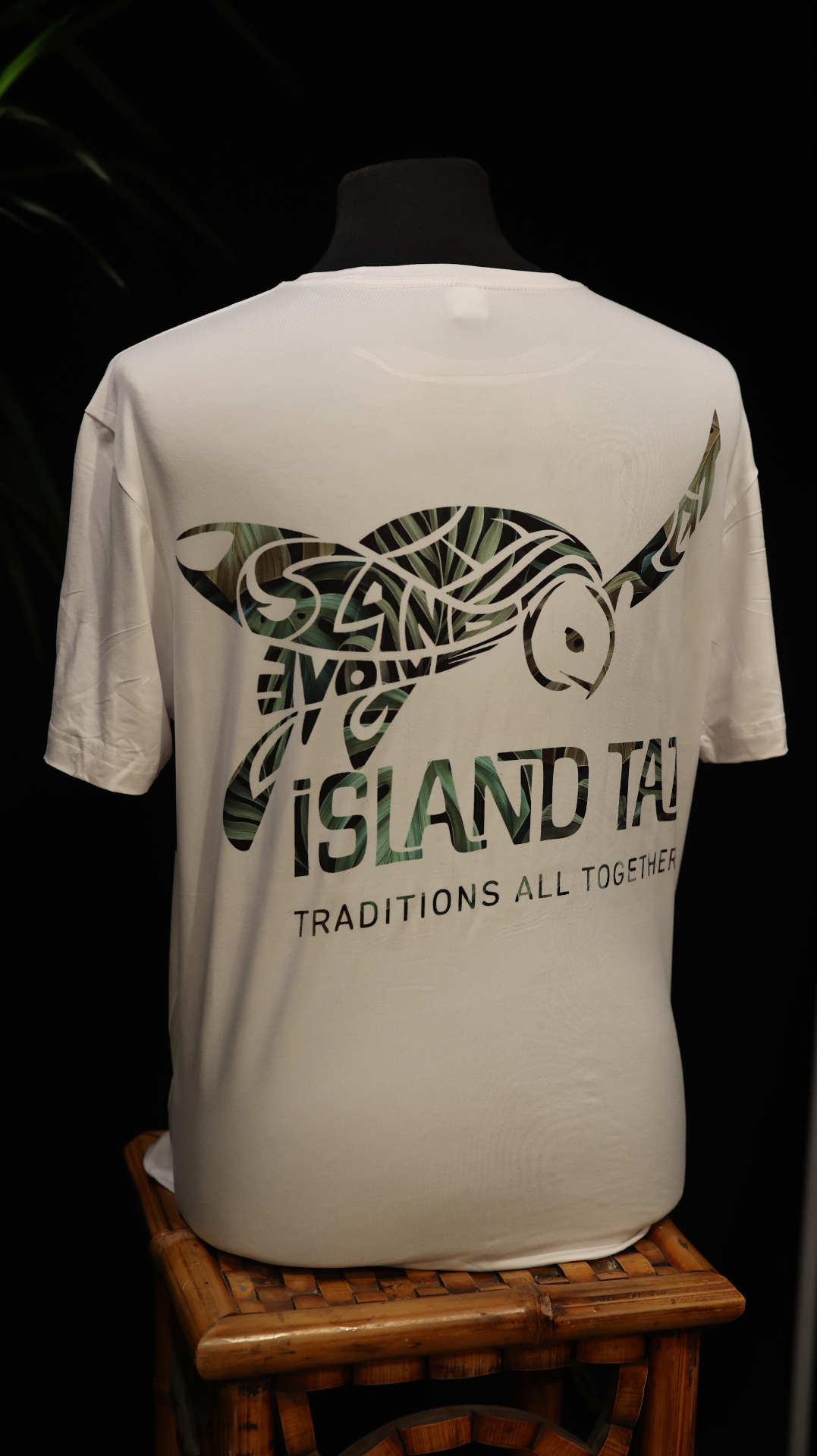 White performance shirt with a large turtle graphic across the back.